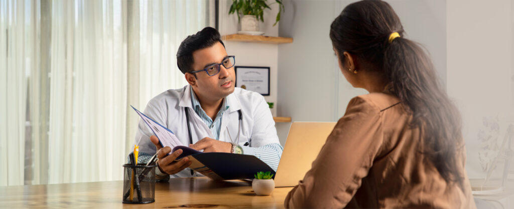 Male physician doctor is encouraging a Young Female patient in hospital clinic